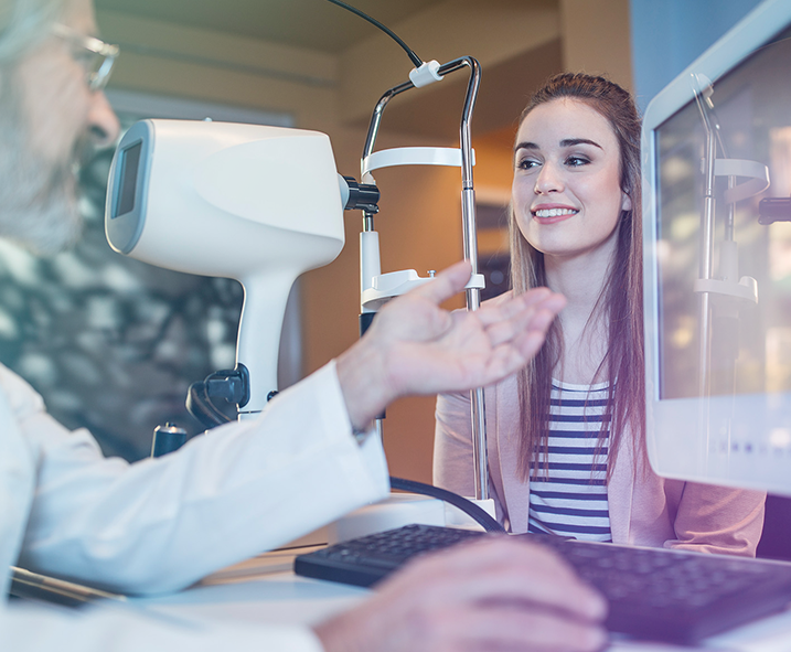 ophthalmologist speaking with woman at eye exam appointment