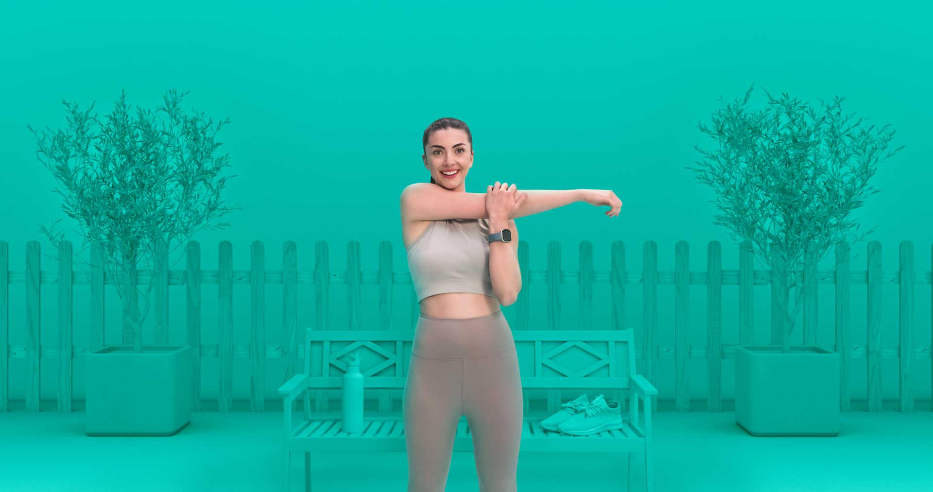 A woman in turquoise green world about to take a run in her tan running gear.