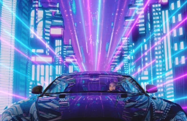 woman driving sleek black sports car with purple and teal city lights reflecting off the car's surface
