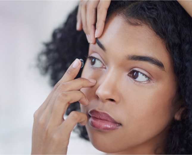 woman applying contact lens