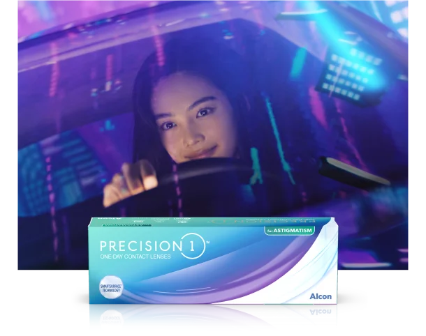 womain driving a car at night with purple and blue lights reflecting off the windshield with a box of Precision1 contact lenses in the foreground