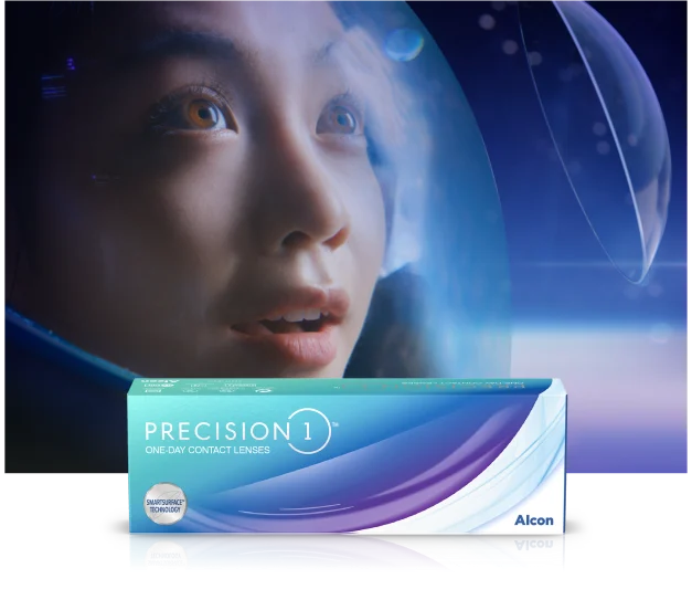 woman wearing astronaut helmet looking at a floating contact lens with a box of Precision1 contact lenses in the foreground