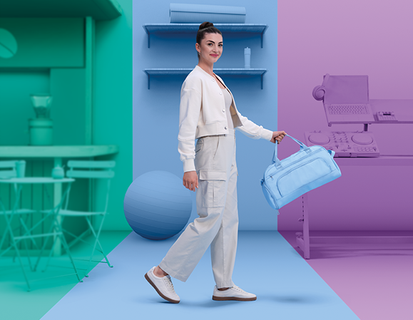 Woman with long brown hair in swimsuit sipping a pink colored drink while reclining on the beach—with Precision1 One Day Contact Lenses product box in foreground